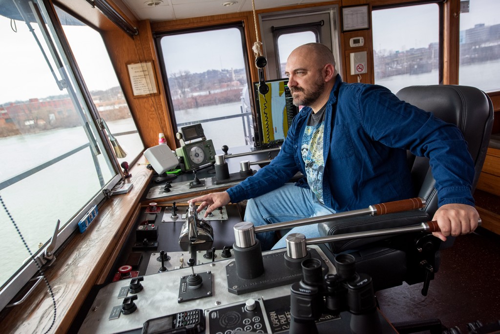 Commercial photographer photosgraphs barges in the Ohio River